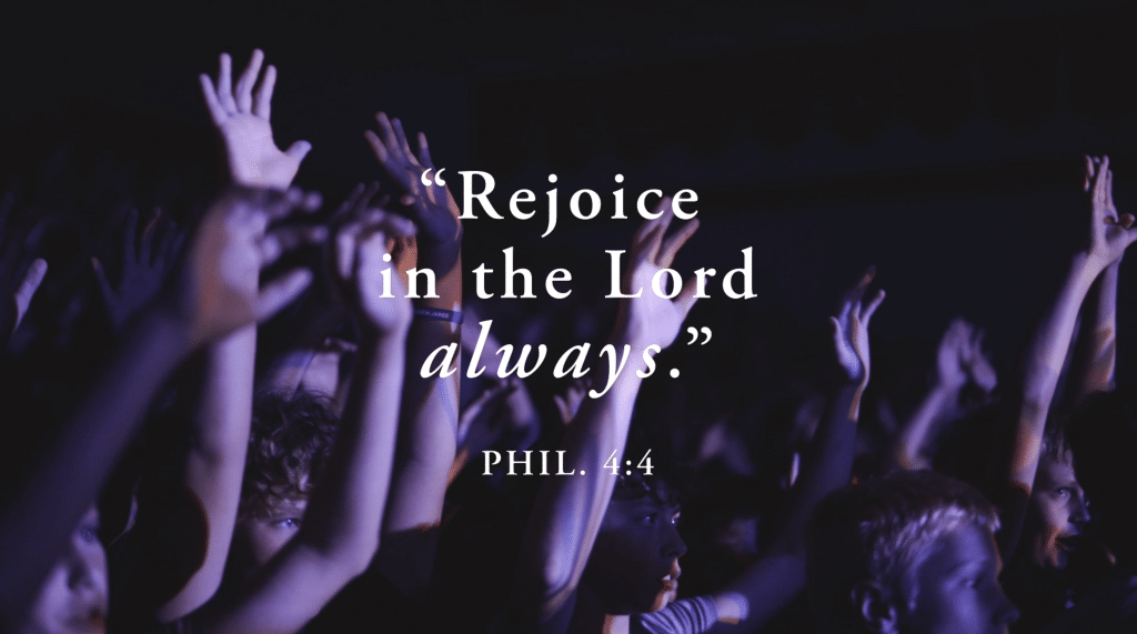 Children raising hands in prayer during Adoration